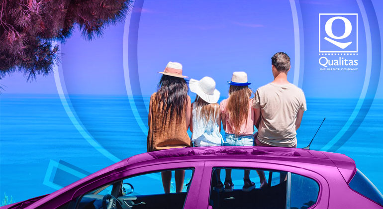 family sitting on top of car viewing the ocean